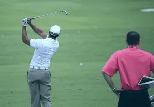 Golfer hitting shot during practice